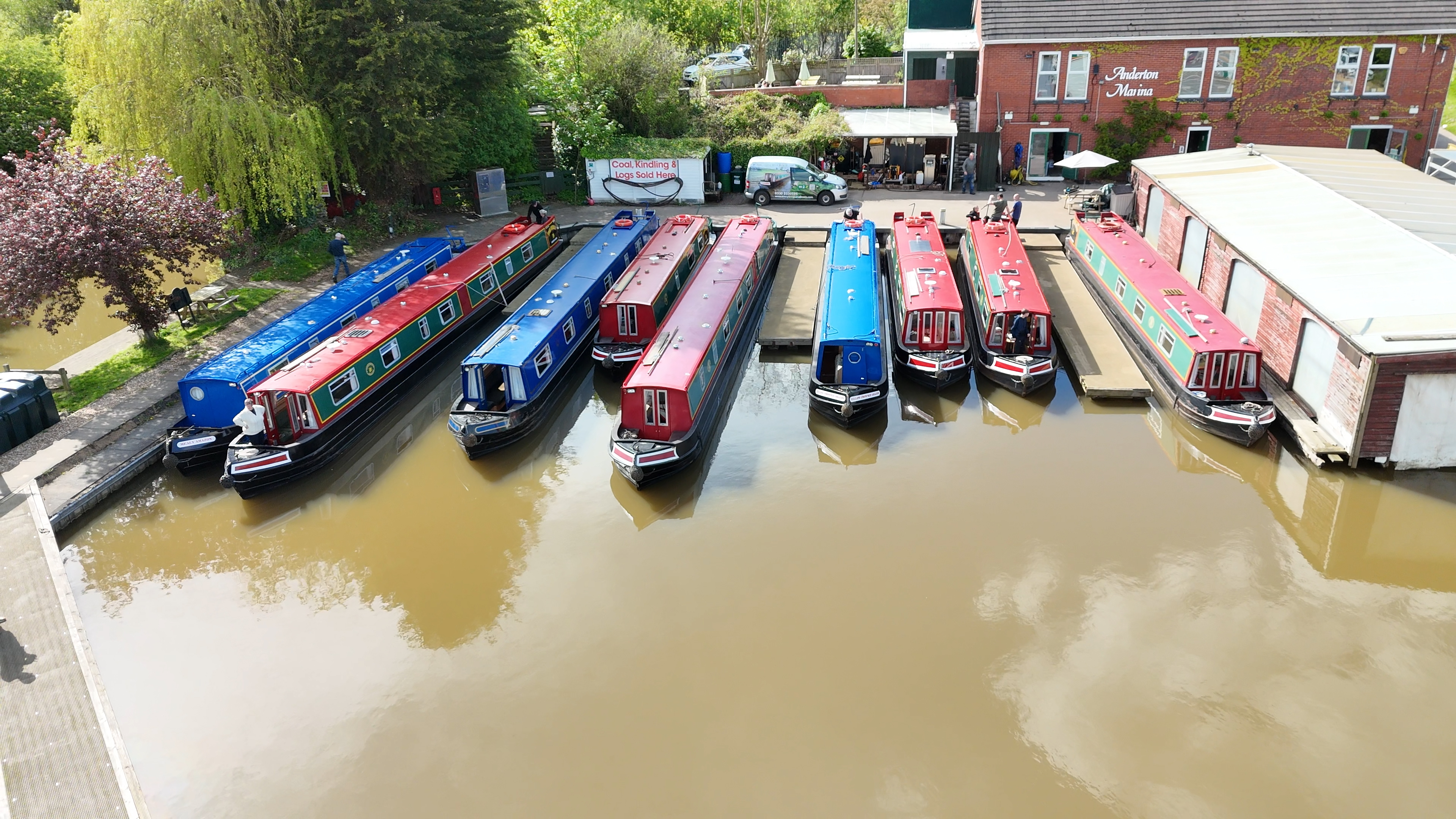 Aerial drone view of colourful narrowboats moored at Anderton Marina