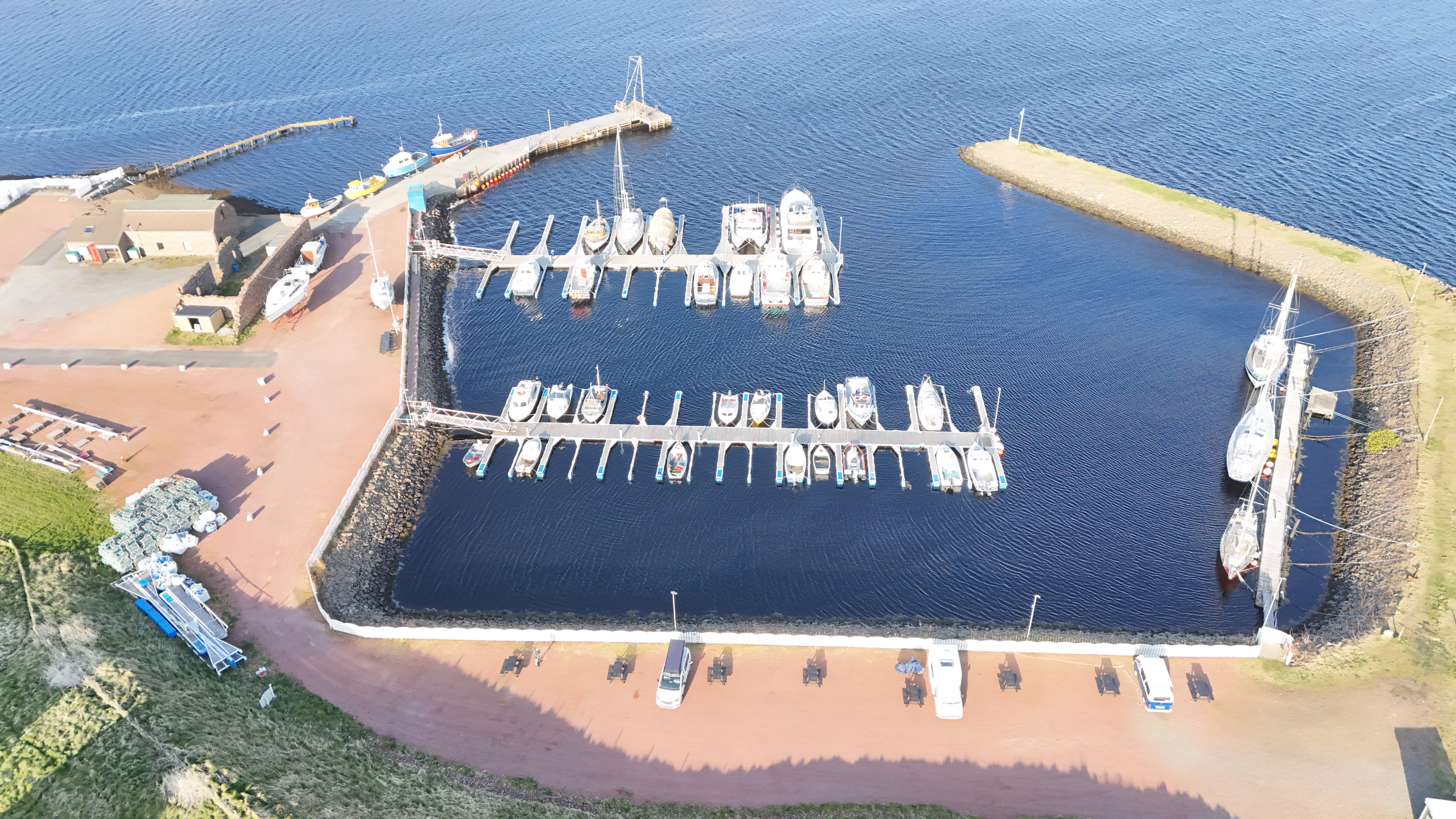 Aerial drone view of Skeld marina with boats moored in Shetland