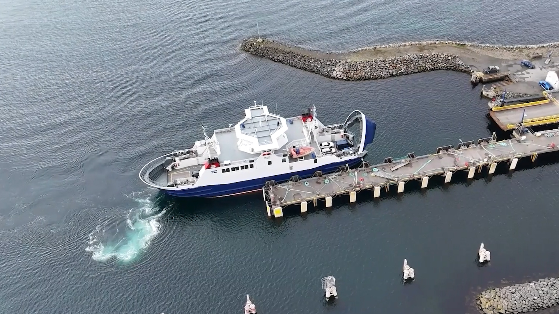Aerial drone shot of Shetland inter-island ferry arriving at harbour on Yell